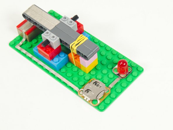 Add a piece of Maker Tape between the Positive side of the Battery Holder and the Positive side of the LED.
