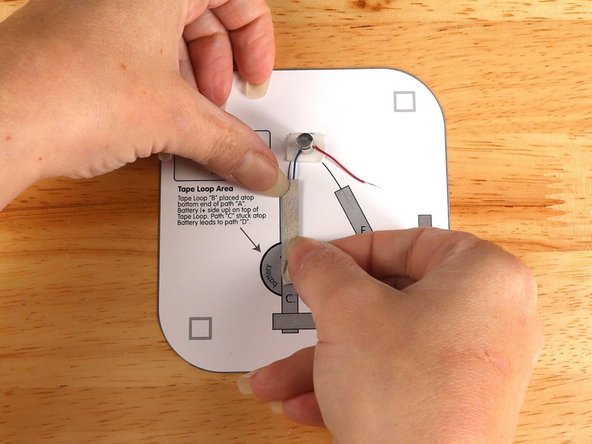 Add Tape Path A. pressing it down atop the blue wire.