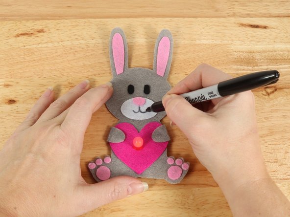 Use a black permanent marker to draw a mouth on the Bunny.
