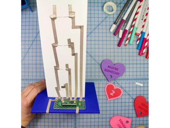 Connect your tape to your Invention Board. Be careful to only cover the copper holes and not overlap any tape.