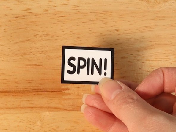 On the back of the &quot;SPIN!&quot; piece, add a couple pieces of Maker Tape vertically in the center.