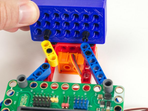 One pin will go into the last hole of the blue beam on the righthand side.