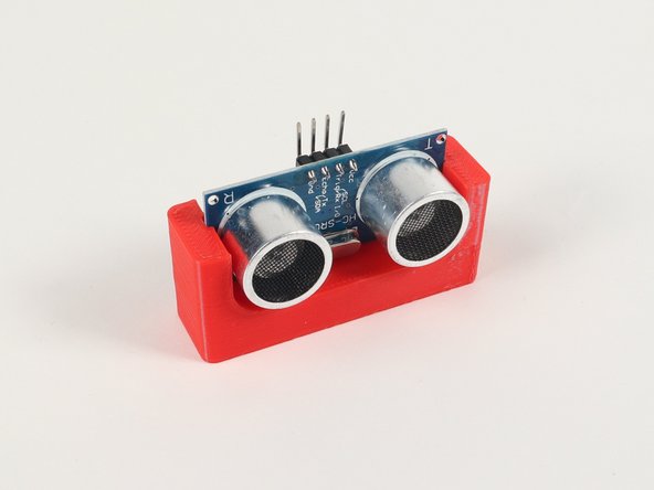 The Distance Sensor Holder with Holes is a 3D printed part that is LEGO Technic compatible.