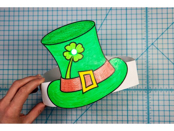 Cut out the side strips and tape them to the hat with the slits facing up on one side and down on the other.