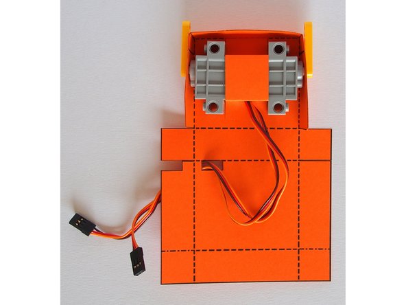 You only need to put glue on the tabs where they attach to the body, not on the servos themselves.