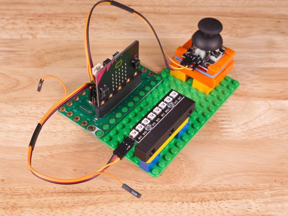 So let's get connected! If you turn the NeoPixel Strip over you'll see labels for the three pins. You should see IN, VCC, and GND.