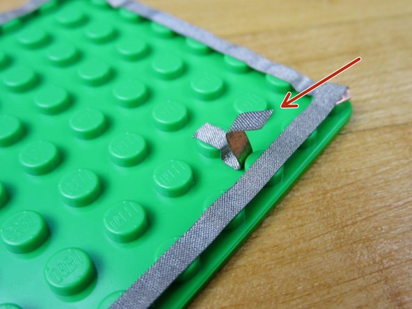 We need to create a tape bridge to connect our &quot;A&quot; Button. Since our Conductive Tape isn't reliably conductive on the sticky side, we need to do a bit of folding.