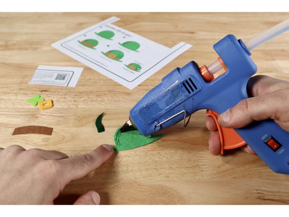 Using the step-by-step pictures on the template sheet OR these photos as a guide, glue the layers together to form the final design. The shadow goes atop the hat. The hat band goes on top of the hat and shadow. The buckle and shamrock are the topmost pieces.