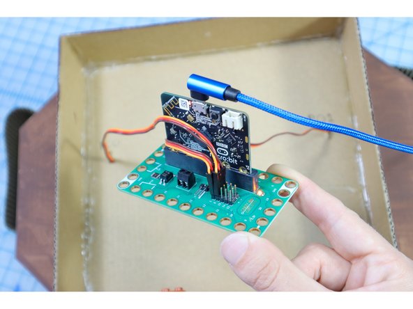 Connect the motor in the fish head to Pin 1 and the motor in the tail to Pin 0 using the pins on the back of the Bit Board. The brown wire is Ground.