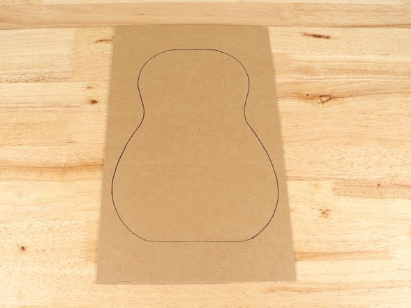 You can use broken down cardboard boxes or cereal boxes. If you use thinner boxes (chipboard) you should cut out 2-3 of the body and neck and glue them together to make a more sturdy build.
