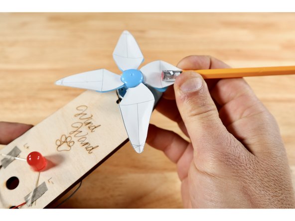 Lay a pencil on top of the guideline that runs directly down the middle of the blade the long way (labeled &quot;b&quot; on the template card diagram) until the eraser meets the line shown (labeled &quot;a&quot; on the template card diagram).  Using the pencil as a form, curl the sides of a given blade.