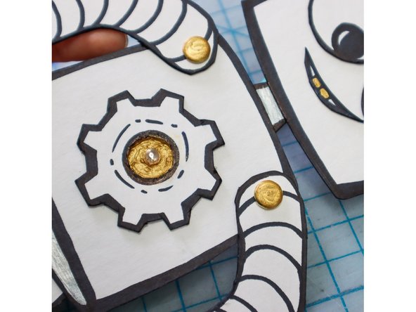 Adding paint, glitter, or metallic marker around the LED will amplify its light.