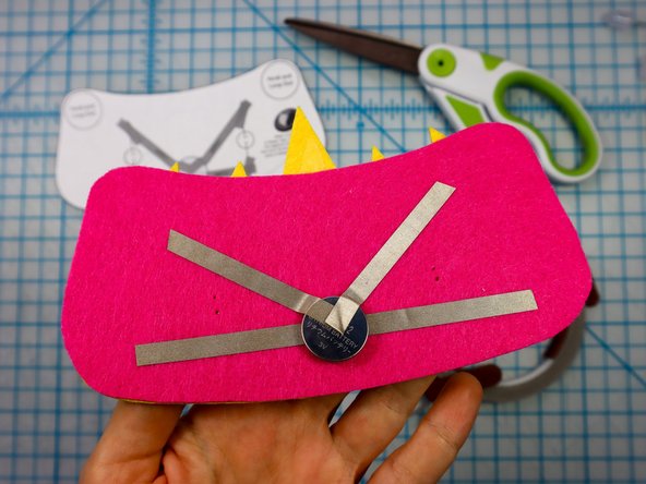 Place the battery on top of the Maker Tape as shown, and add the &quot;V&quot; shaped piece on top.