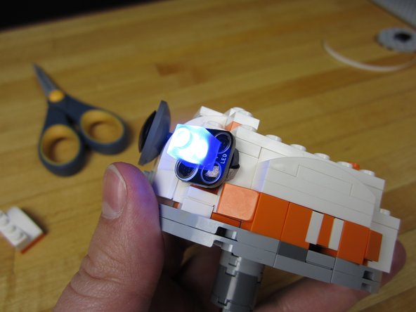 Trim your lines of tape and attach them to the studs.