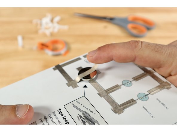 Stick the battery atop the tape loop with the Positive (+) Side facing UP.