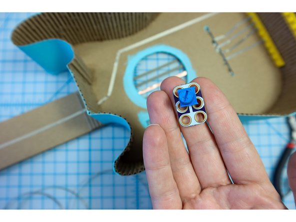 Thread three long pieces of Maker Tape through the top, middle, and bottom holes of the potentiometer making a good connection to each.