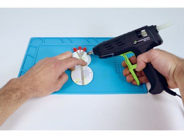 Flip your project over to the bottom and apply hot glue to one of the areas near the LEDs.