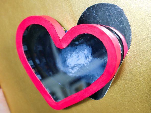 Then position the heart box over the mirror paper heart and glue it in place. Remove any excess glue from the outside of the heart.