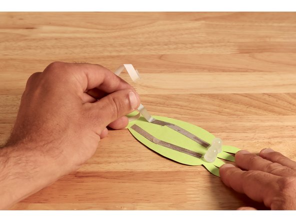 Lay Maker Tape pathways on top of each of the LED legs on the front side so that the two paths are close to one another at the fold line of the tab.