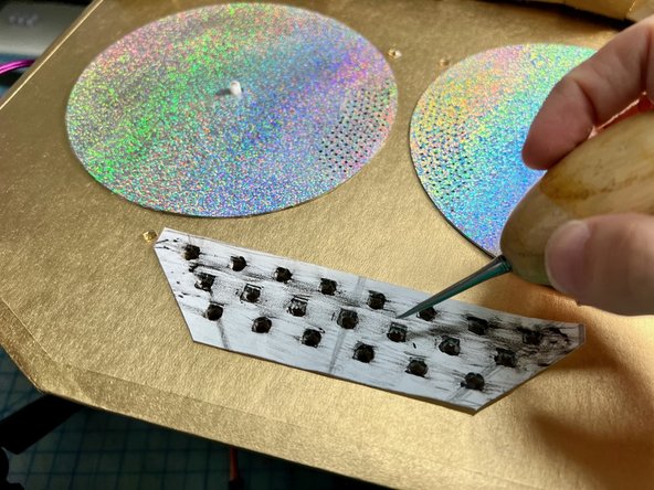 Place the template where the mouth goes. Use an awl to poke each hole.