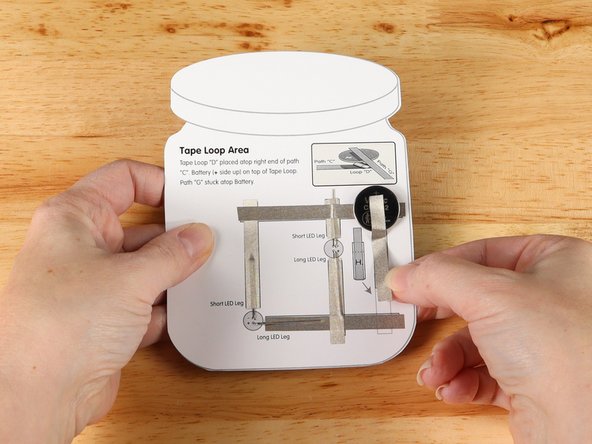 Add Maker Tape to path G connecting the top (Positive) side of the battery to the diagram.