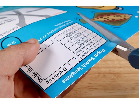 Cut and remove one of the &quot;Control Box Lever Switch&quot; templates from the upper right corner of the Flat Fish project poster. Fold it on the dotted line.