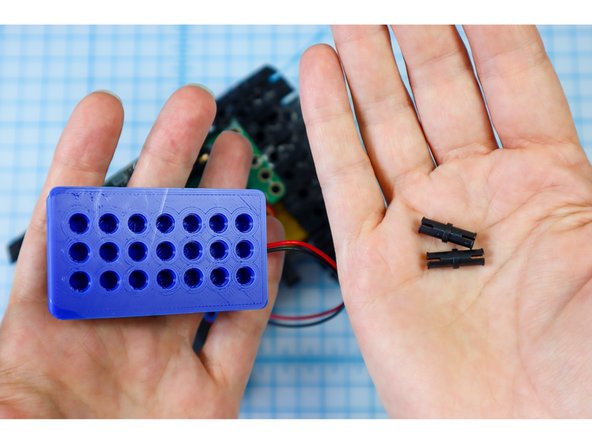 Disconnect the battery pack and remove the black pins.