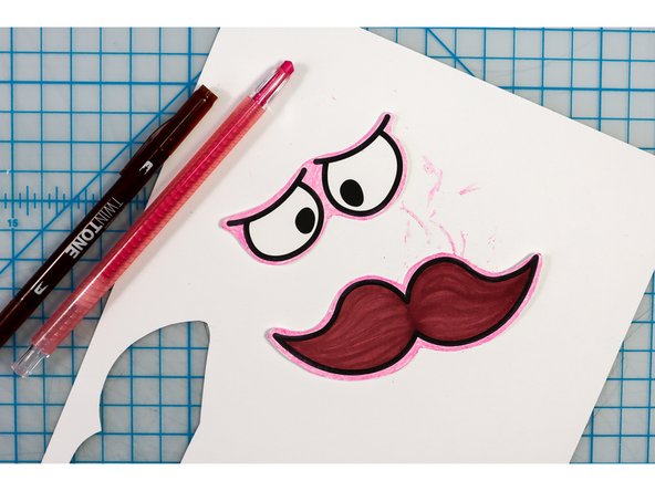 Choose funny face features from the template and color in the ones you pick, then cut them out.