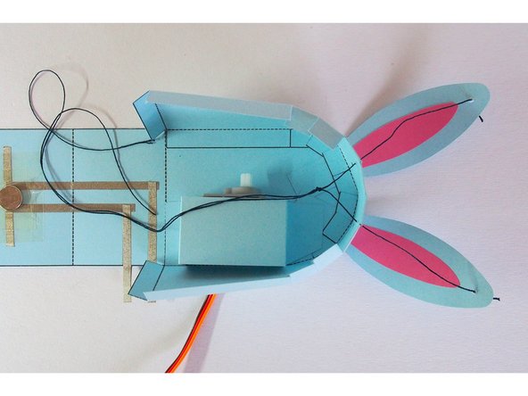 Tie the two strings together just above the servo