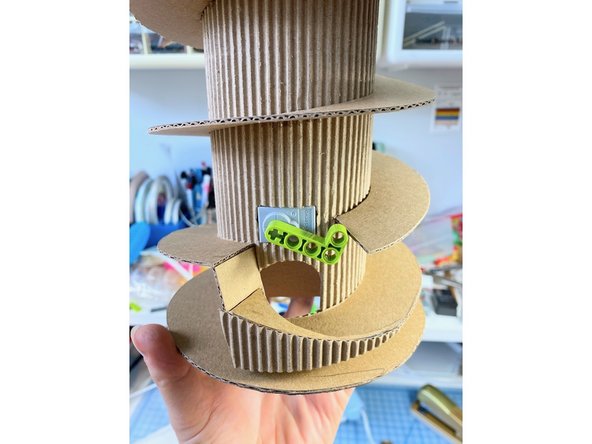 We created an extra piece that directs the gumball through the hole. We added the front triangle to this piece for decoration.