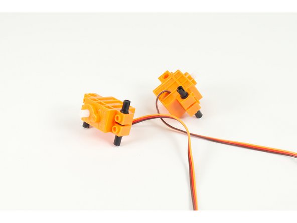 Once done adding all pins flip the servos over again so they are right-side up.