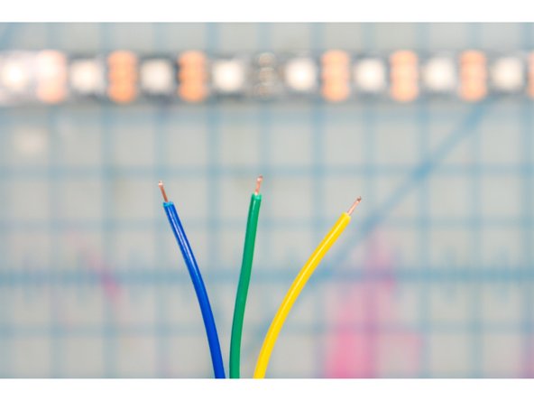 Solder three hookup wires to the +5V, DI, and GND pads on the LED strip.