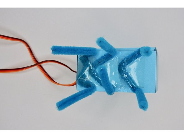 Glue or tape the legs to the bottom of the body.