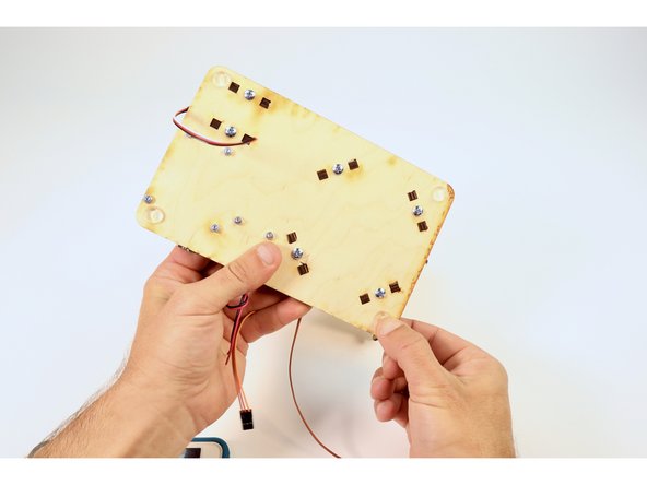 Peel and stick them in the corners on the underside of the Solar Tracker base plate.