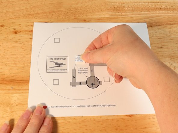 Add a piece of double-sided foam tape to the center of the bottom layer.