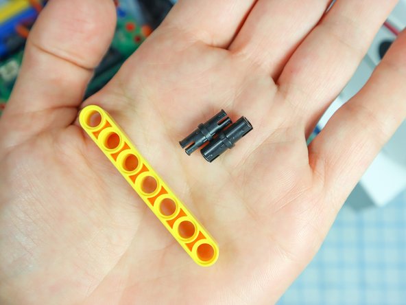 Use two pins to add a LEGO beam to the front of the Rover as shown.