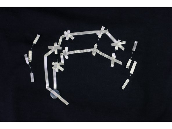 Use another long piece of Maker Tape to connect over the top of the battery (+) and continue to all of the positive LED legs.
