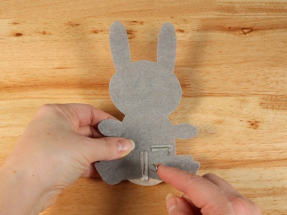 Make a loop of tape (sticky side out) using a short piece of Maker Tape, and stick it atop the end of the path coming from the short (Negative) LED leg.