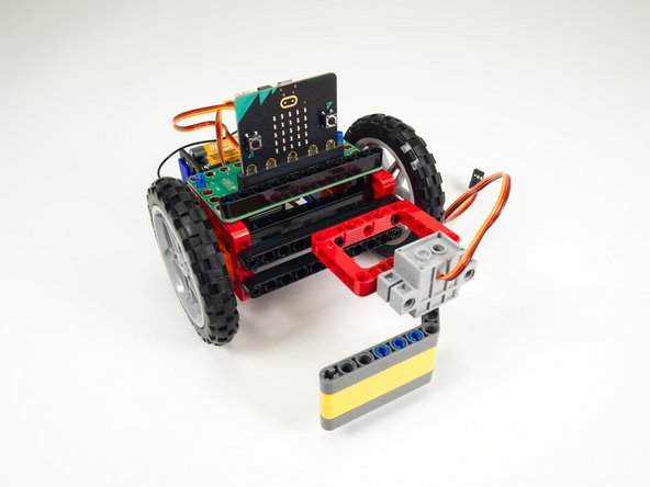 Attach the Sweeper to the top beam on the front of the Rover.