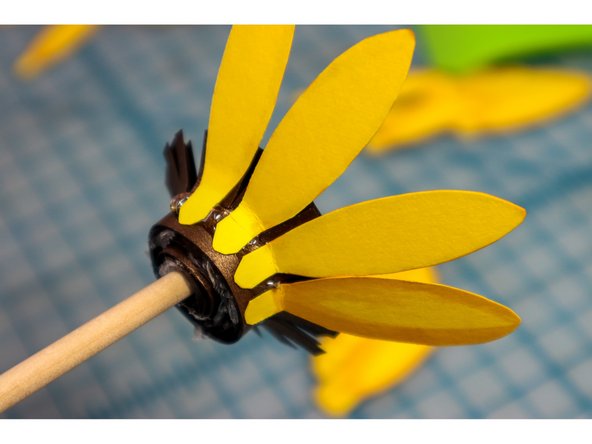 Glue the petals around the flower center. There should be enough to make about 3 rows.