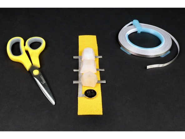 Now the negative LED legs are electrically connected to the negative (bottom) side of the battery by the tape loop.