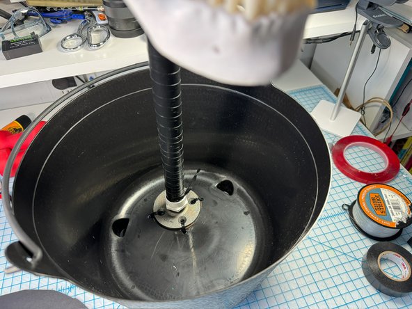 Secure the flange to the plastic cauldron by drilling holes and connecting with zip ties as shown.