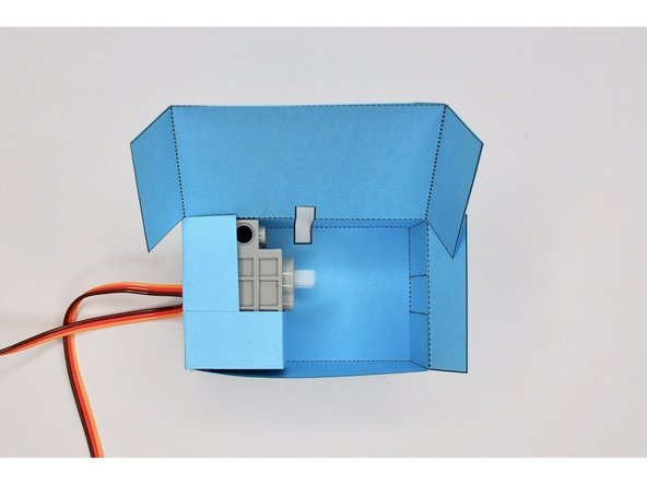 Wrap the servo holder around the two servos and glue it to the left-hand tab to hold it in place.