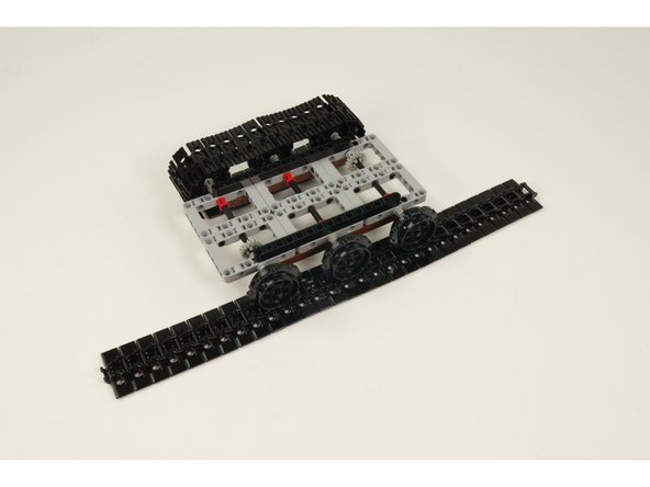 Wrap the treads around the sprockets and attach into a loop by clicking the two end treads together on each set of treads.