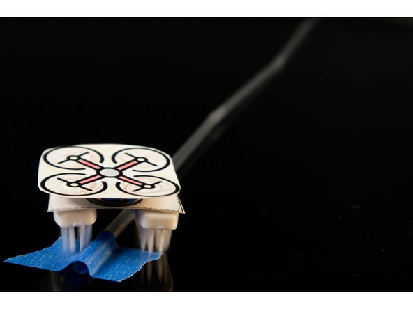 If you are doing a single line track, you can use a large piece of tape to stop or slow down your bot when it hits it. The bristles just don't propel it over the tape as easily as the smooth table surface.