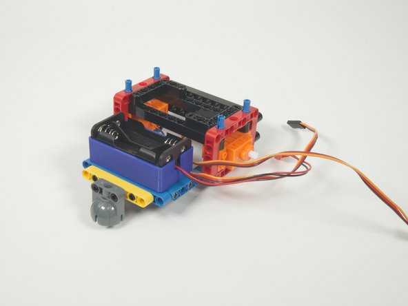 Add the battery holder by pressing it down onto the pins as shown centering the battery holder on the pins.