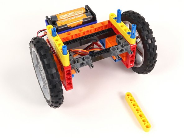 Since 2/3rds of the blue pins are sticking out, you'll need to make sure to push the yellow beams down all the way so they are touching the other yellow beams. 1/3 of the blue pins should still be sticking out.