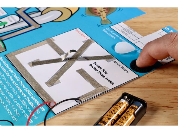 Peel and stick the fuzzy half of one of your hook and loop dots onto the circle labeled &quot;motor&quot;