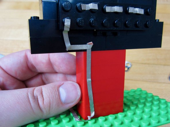 Run a long line of tape from the far left LED to Pin 2 on the Robotics Board.