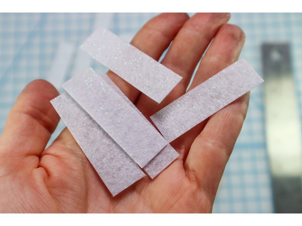 Cut out the &quot;candle&quot; rectangles from the white glitter felt.